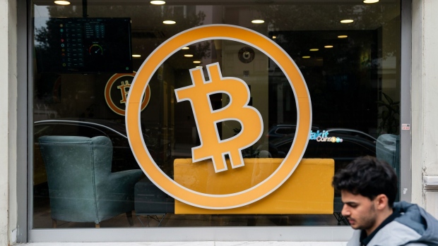 A bitcoin logo in the window of a cryptocurrency exchange bureau in Istanbul, Turkey, on Friday, March 1, 2024. Bitcoin has jumped over 40% already this year atop the successful debut of the US ETFs, which directly hold the token. Photographer: David Lombeida/Bloomberg