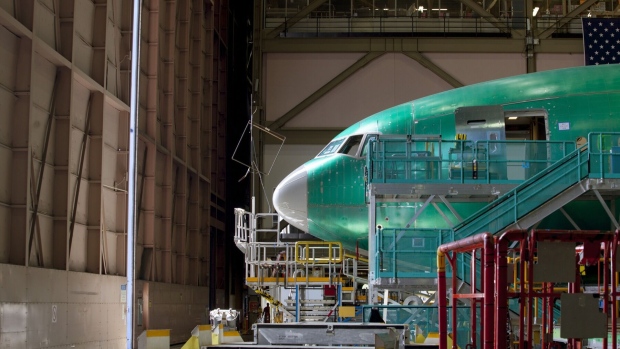 A nearly completed Boeing Co. 777 reaches the end of the production line at the company's facility in Everett, Washington. Photographer: Mike Kane/Bloomberg