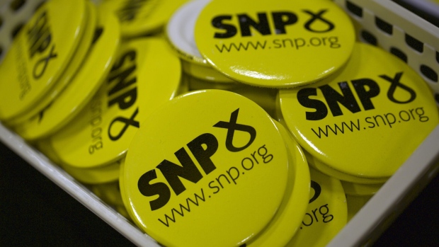 Scottish National Party (SNP) branded badges sit on display for sale during the annual Spring Conference at the Aberdeen Exhibition and Conference Centre (AECC) in Aberdeen, U.K. on Friday, March 17, 2017. Sturgeon wants to be able to offer Scots the choice between leaving the EU with Britain, or becoming an independent nation with access to the EU’s single market. Photographer: Matthew Lloyd/Bloomberg