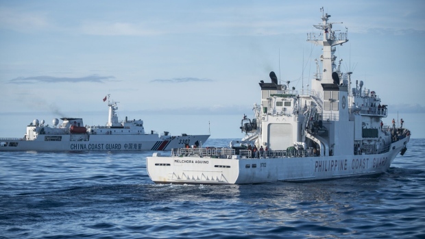 <p>A Philippine Coast Guard ship near a China Coast Guard ship in the disputed South China Sea.</p>
