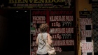 A shopper looks at prices displayed at butcher shop in Buenos Aires, Argentina, on Wednesday, Jan. 10, 2024. Argentina's annual inflation rate is poised to surpass Venezuela in December, making it by far the highest in the region and one of the top in the world.