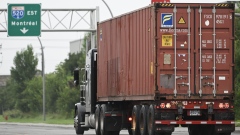 A transport truck pulls a freight container in Montreal. Canada recorded a goods trade deficit of C$2.28 billion in March, with exports falling 5.3%.