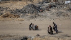 Displaced Palestinians amongst ruined buildings after fleeing from Rafah on May 7.