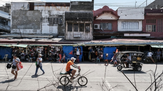 <p>The Philippines trimmed economic growth forecasts for this year and next amid stubborn inflation and elevated interest rates, while widening its fiscal deficit estimates to support higher spending.</p>