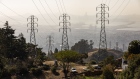 <p>Power transmission lines above homes in Oakland, California.</p>