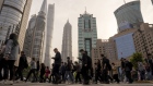 Pedestrians cross a road in Pudong's Lujiazui Financial District in Shanghai, China, on Monday, April 15, 2024. China's economic growth beat expectations in the first quarter as the industrial sector powered forward, although a tail-off in March activity signaled more support may be needed to sustain that momentum. Photographer: Raul Ariano/Bloomberg