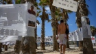 A beachgoer visits a makeshift memorial at a beach in Tel Aviv, on May 12, 2024.
